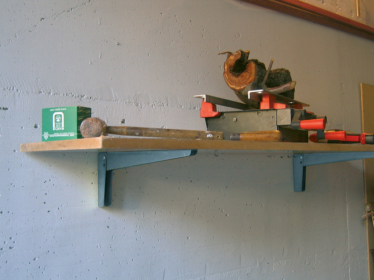 Mensola in acciaio verniciato grigio con attrezzi da lavoro sopra.