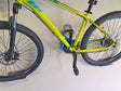 Bicicletta gialla con supporto a parete e lucchetto a cavo azzurro